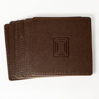 Stack of brown square leather mahjong coasters with embossed Club Mah Jongg icon