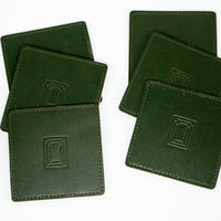Fanned stack of dark green square leather mahjong coasters