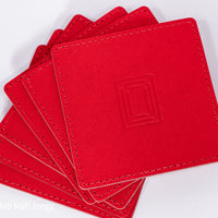 Fanned stack of red square leather mahjong coasters
