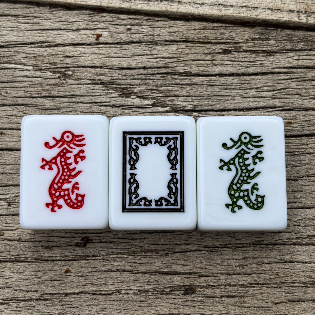 Three white mahjong tiles from Club Mah Jongg&